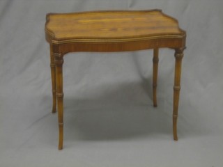A Georgian style figured walnut occasional table of serpentine outline, raised on cabriole supports 21"