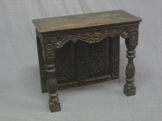 An 18th/19th Century carved oak court cupboard back, raised on turned and block supports 25" 