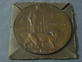 A WWI Death Plaque to Stanley Ewins complete with Buckingham Palace letter and original cardboard packing