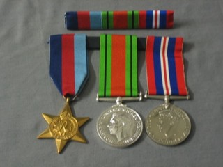 A  copy group of 3 medals comprising 1939-45 Star, Defence and War medal complete with ribbon bar and certificate