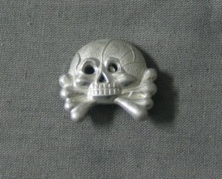 A Death Head cap badge for Waffen SS