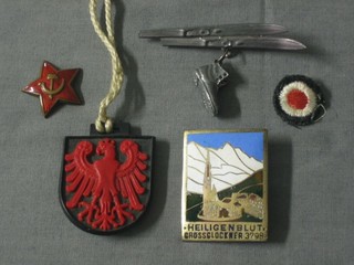 An enamelled Soviet Red Army badge, an enamelled badge marked Heiligenblut Gross Glockner 3798, a German cloth dot badge, a Polish plastic pendant and a brooch in the form of a pair of skis and boot