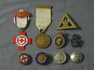 A German enamelled badge, heavily scratched, a WWI Red Cross service medal and various other badges