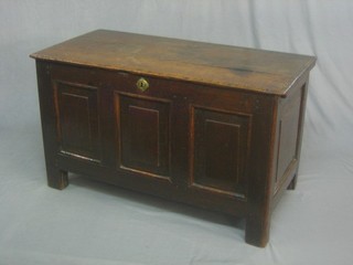 An 18th Century elm coffer of panelled construction the interior fitted a candle box with hinged lid 39"
