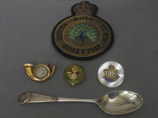 A Bisley 1937 Burma rifle team blazer badge, a Kings Own Yorkshire Light Infantry silver trophy spoon, a Koyli enamelled association cap badge, collar dog and a sweetheart brooch