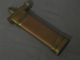 A rectangular reproduction copper and brass powder flasks 4 1/2" and an oval powder flask with shell decoration