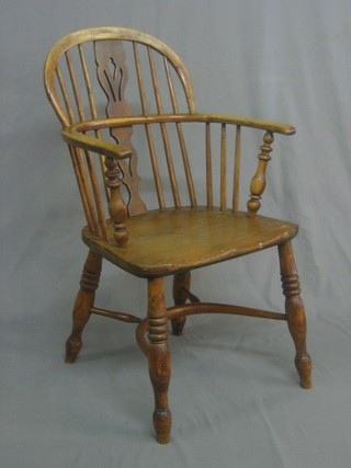 A 19th Century elm carver chair with cow horn stretcher, raised on turned supports