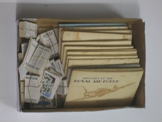 A collection of various cigarette cards