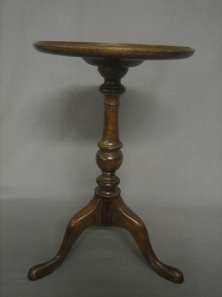 A Georgian style mahogany wine table raised on pillar and tripod supports 12"