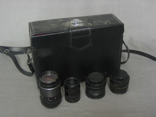 A black leather case containing 3 various lenses etc