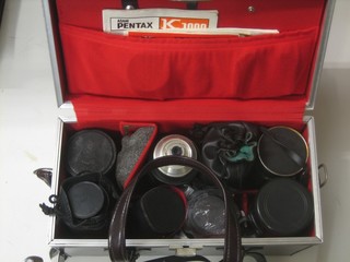 A Hoya 35-75mm lens, an Osawa 80-205mm lens, an Prinzflex 135mm lens, a Soligor 80-200mm lens, a Vivitar teleconvertor lens, a Rollie 135mm lens (all cased), together with a Retina Longuard Zenon Schneider-Kreuznach lens, a Paracon 80-200mm lens, a Canon 50mm lens and a Pentax teleconvertor lens, contained in a brown leather equipment case