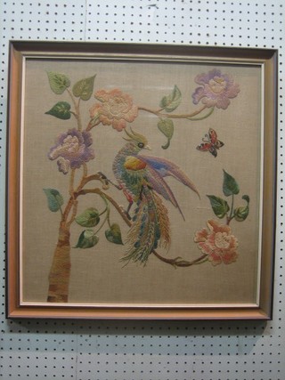 A needlework picture of a fabulous bird amidst branches 20" x 20"