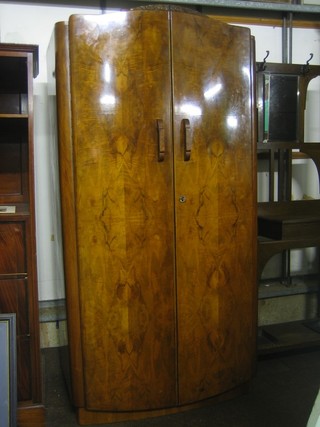 A gentleman's Art Deco figured walnut bow front wardrobe 37"