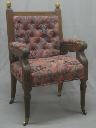 A Victorian carved oak open arm chair with upholstered seat and back by G E Street (back leg with old repair) 