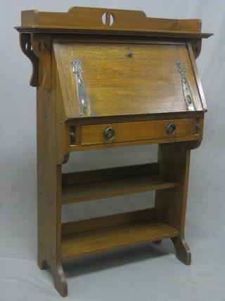A student's oak Art Nouveau bureau, the raised back with fall front revealing a fitted interior above 1 long drawer, the base fitted 2 shelves 33"
