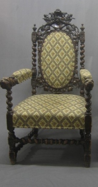 A Victorian carved oak Carolean style carver chair the seat upholstered in tapestry material