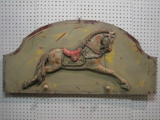 A carved arch shaped panel decorated a carousel horse 32"