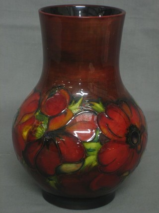 A Moorcroft flame Anemone pattern club shaped vase, the base impressed Moorcroft, signature mark and Made in England 9" 