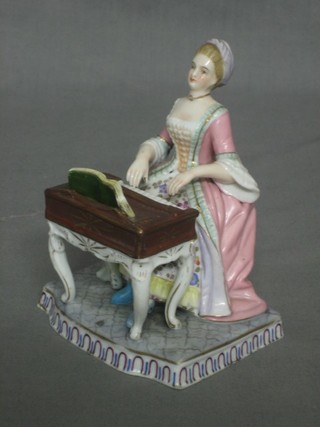 A Meissen style figure of a seated lady playing a piano, the base with cross swords mark (chip to base) 5"