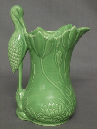 A green glazed Sylvac pottery jug, the handle in the form of a stork, base marked 1960 Sylvac 7"