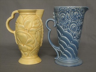 A Wade yellow glazed pottery jug, base marked 1144 9", together with a Wade blue glazed jug 9"