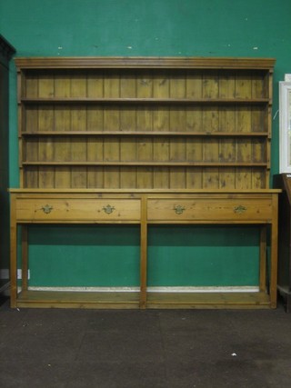 A 19th/20th Century pine dresser, the raised back fitted 3 shelves, the base fitted 2 long drawers above a potboard 85"
