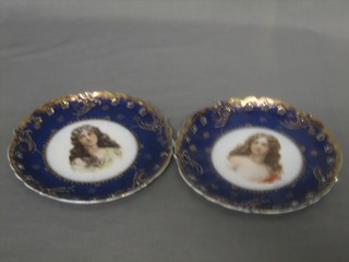A  pair of 19th Century circular Continental porcelain plates with blue and gilt banding, the centres decorated portraits of girls 8 1/2"