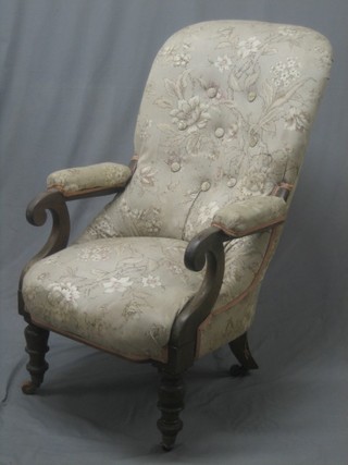 A William IV mahogany tub back open arm chair upholstered in floral material