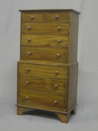A Victorian style mahogany apprentice chest on chest, the upper section fitted 2 short drawers above 3 long drawers, the base fitted 3 long drawers, raised on bracket feet 12"