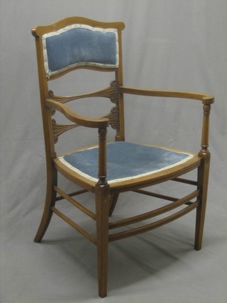 An Edwardian inlaid mahogany open arm chair, raised on square tapering supports