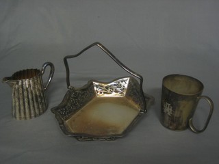 A pierced silver plated cake basket with swing handle, a Victorian silver plated cream jug and a silver plated tankard
