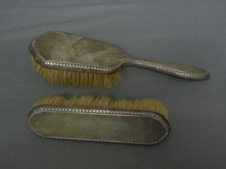 A silver backed clothes brush and a do. hair brush