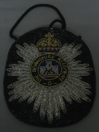 A lady's beadwork evening bag decorated the badge of the Devonshire Regt.