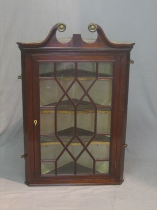 A Georgian mahogany hanging corner cabinet with broken pediment, fitted shelves enclosed by astragal glazed panelled doors 28" 