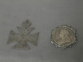 A gun metal cross surmounted by a crown and a Victorian Jubilee silver brooch