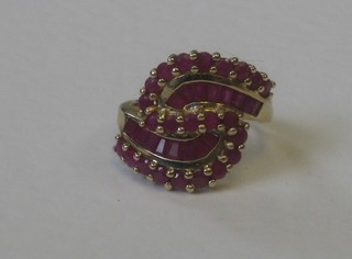 A lady's gold dress ring set baguette and round cut rubies