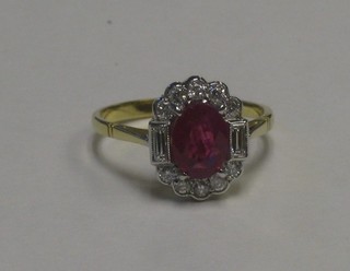 A lady's 18ct yellow gold dress ring set an oval cut ruby having 2 baguette cut diamonds to the shoulders supported by numerous diamonds 