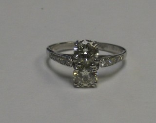 A lady's 18ct gold dress ring set 2 large diamonds and with numerous diamonds to the shoulders approx 1.51/0.20ct