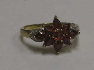 A gold dress ring set amber coloured stones and diamonds