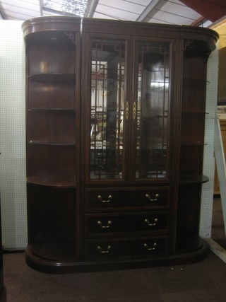 A good quality mahogany D shaped wall unit, the centre section fitted shelves enclosed by a pair of astragal glazed panelled doors, the base fitted 3 long drawers flanked by a pair of corner cabinets 68"