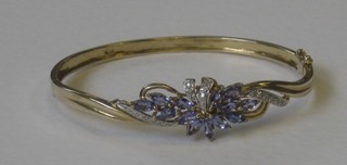 A lady's 9ct gold bangle set diamonds and tanzanite
