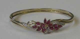 A lady's 9ct gold bangle set rubies and diamonds