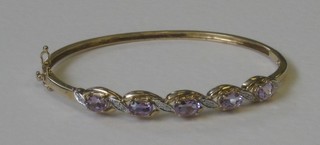 A lady's 9ct gold bracelet set amethysts and diamonds