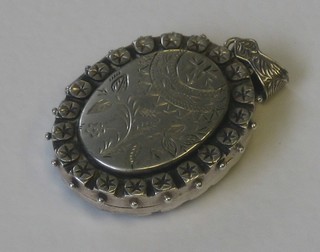 An oval Victorian engraved silver locket