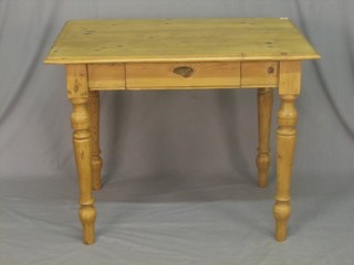 A rectangular pine kitchen table, the frieze fitted a drawer, raised on turned supports 39"