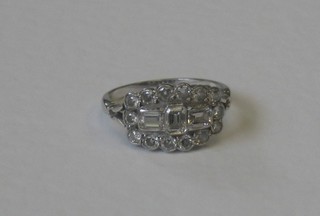 A lady's Art Deco style 18ct white gold dress ring set baguette cut diamonds surrounded by numerous diamonds, approx 1.35ct 