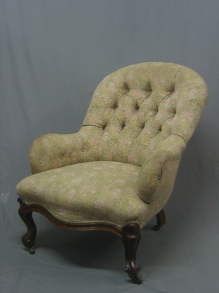 A Victorian mahogany tub back chair upholstered in buttoned material, raised on cabriole supports