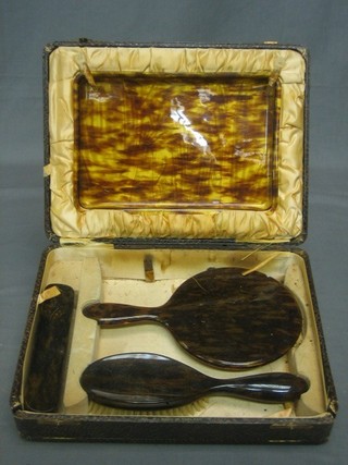 A 4 piece simulated tortoiseshell backed dressing table set with tray, hair brush, clothes brush and mirror