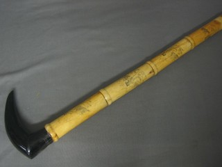 A carved ivory and horn walking stick