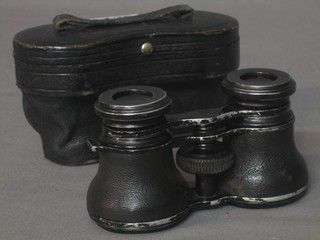 A pair of opera glasses with leather case